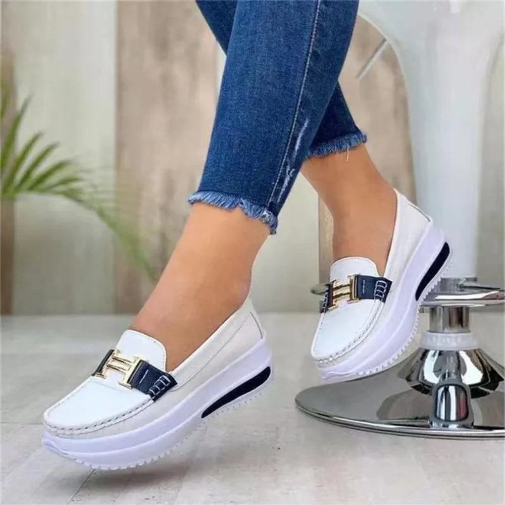Women's platform moc-toe loafers with metal trim and raised sole