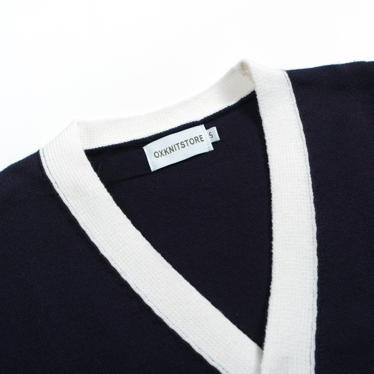 Men's navy cardigan with pale contrast trim and button front