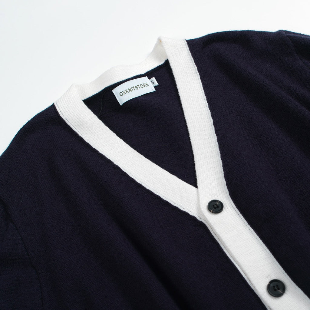 Men's navy cardigan with pale contrast trim and button front