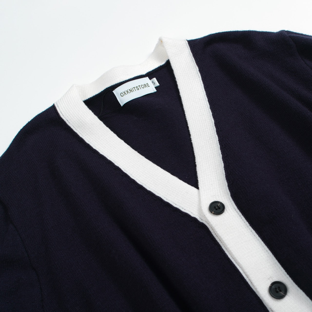 Men's navy cardigan with pale contrast trim and button front