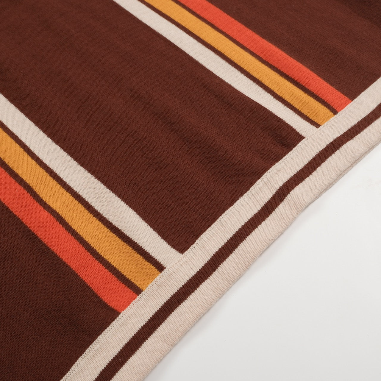 Men's brown knit polo with vertical retro stripes and short sleeves