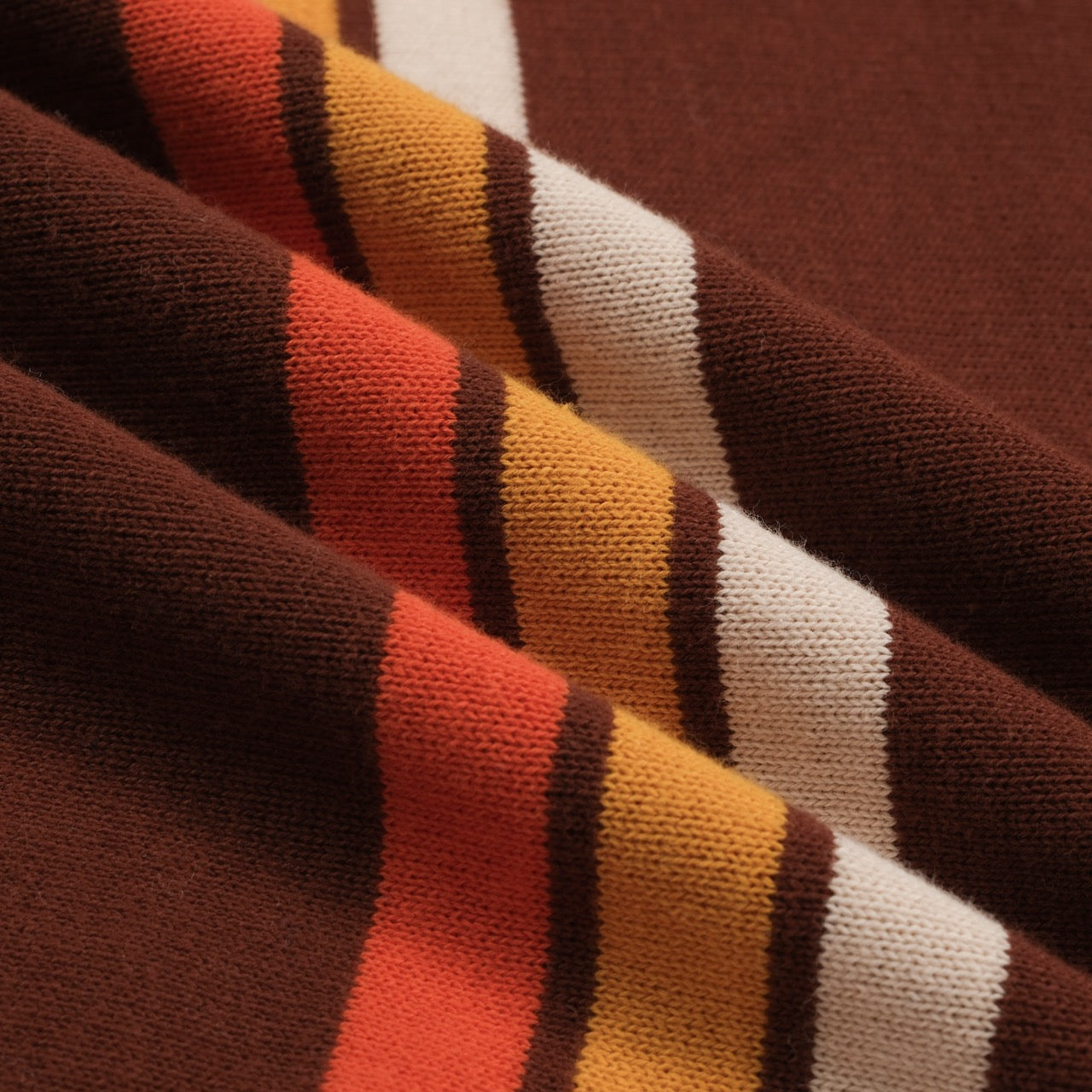 Men's brown knit polo with vertical retro stripes and short sleeves
