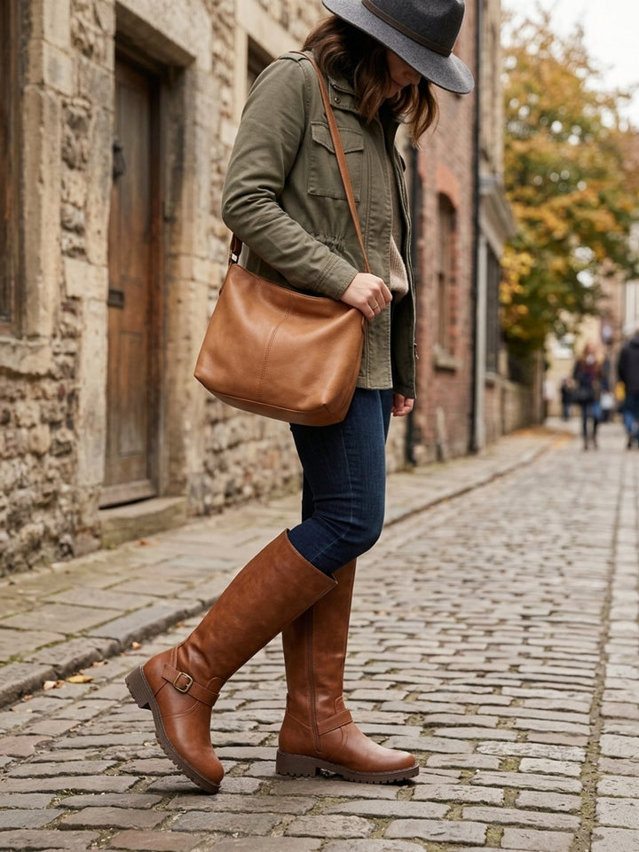 Women's knee-high boots with side zip, buckle strap and lug sole