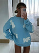 Women's knitted jumper with scattered contrasting motifs