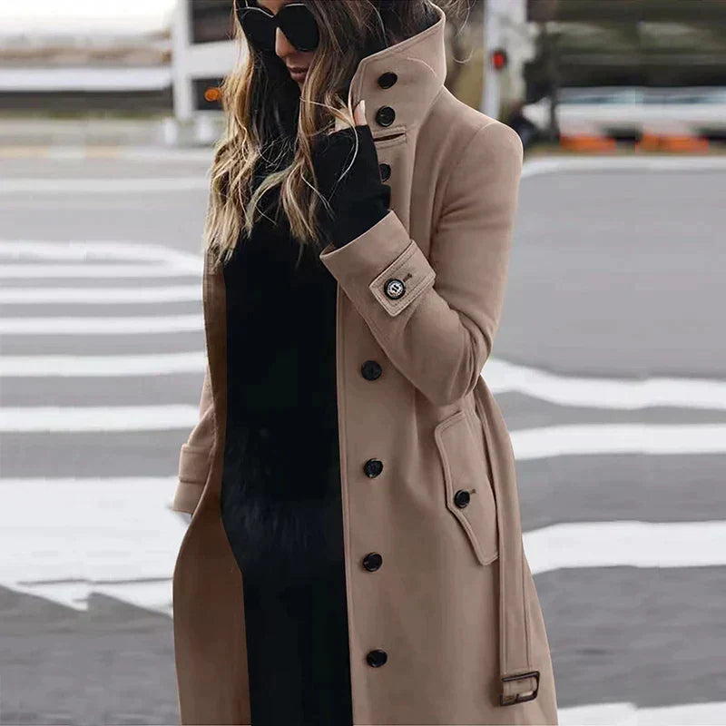 Women's long belted double-breasted trench coat with raised collar and cuff straps
