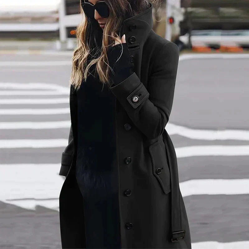 Women's long belted double-breasted trench coat with raised collar and cuff straps