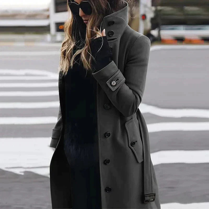 Women's long belted double-breasted trench coat with raised collar and cuff straps