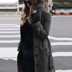 Women's long belted double-breasted trench coat with raised collar and cuff straps