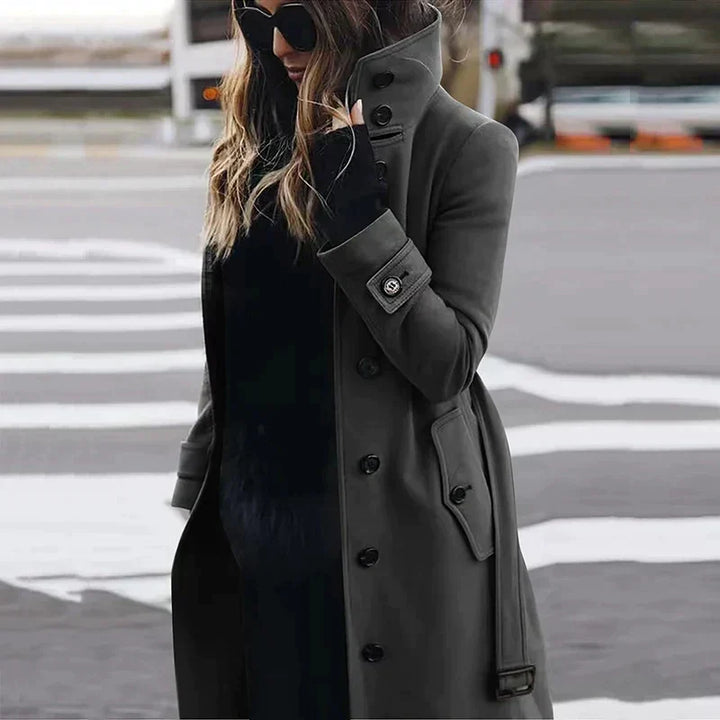 Women's long belted double-breasted trench coat with raised collar and cuff straps