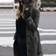 Women's long belted double-breasted trench coat with raised collar and cuff straps