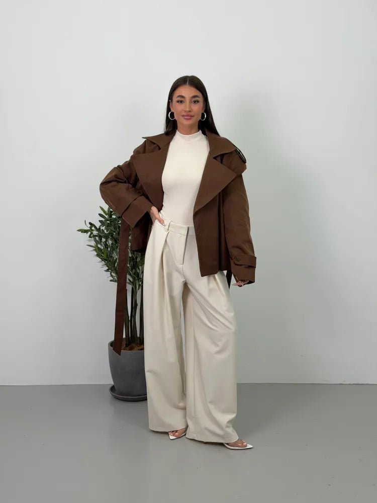 Women's brown cropped trench coat with wide lapels and tie belt