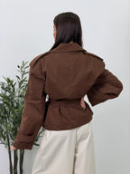 Women's brown cropped trench coat with wide lapels and tie belt