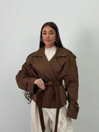 Women's brown cropped trench coat with wide lapels and tie belt