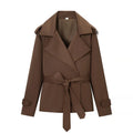 Women's brown cropped trench coat with wide lapels and tie belt