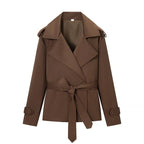 Women's brown cropped trench coat with wide lapels and tie belt