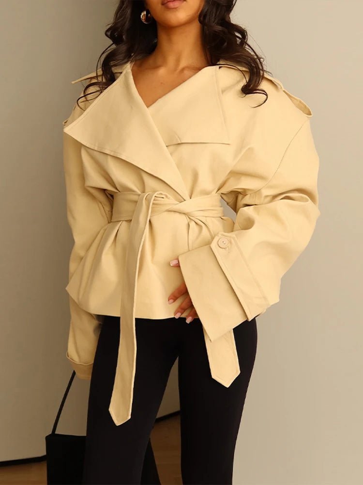 Women's cropped belted trench coat with wide lapels and long sleeves