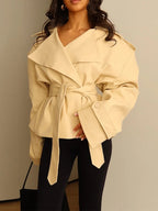 Women's cropped belted trench coat with wide lapels and long sleeves