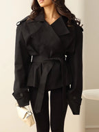Women's cropped belted trench coat with wide lapels and long sleeves