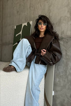 Women's dark brown biker jacket with lapels, diagonal zips and belted waist