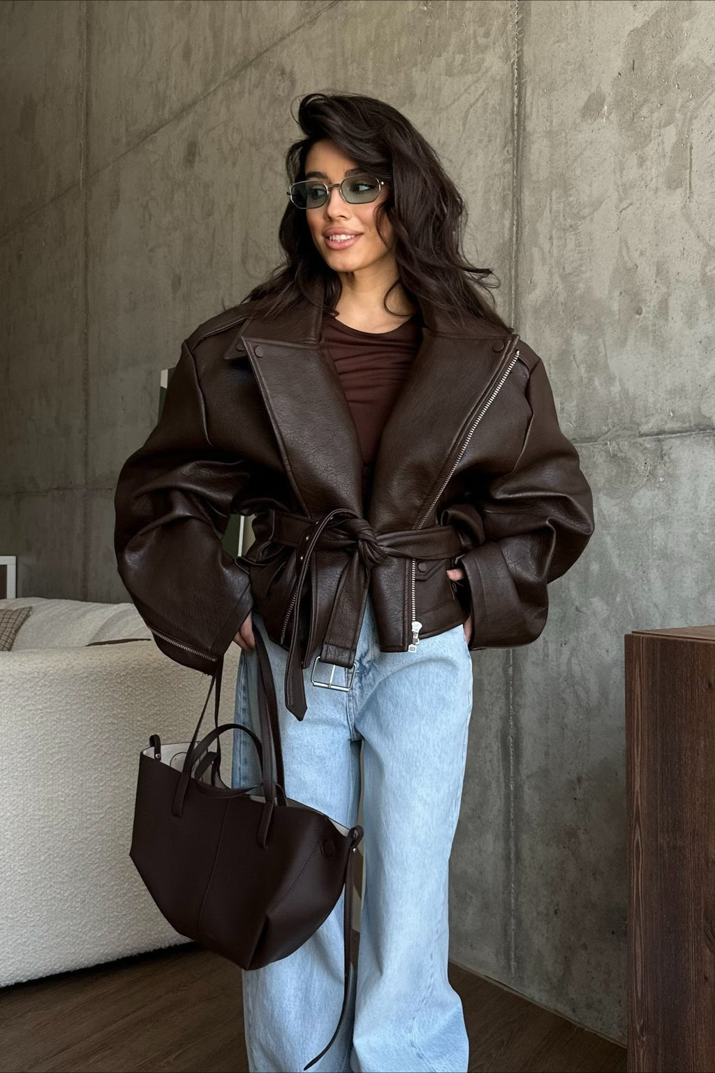 Women's dark brown biker jacket with lapels, diagonal zips and belted waist