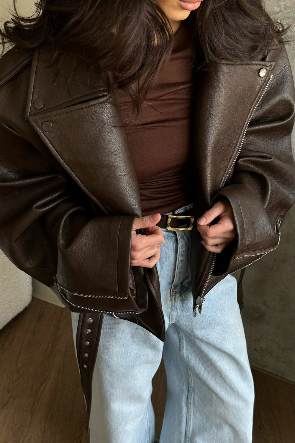 Women's dark brown biker jacket with lapels, diagonal zips and belted waist