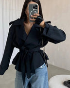 Women's cropped belted trench coat with wide lapels and long sleeves