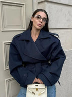 Women's cropped belted trench coat with wide lapels and long sleeves
