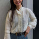 Women's white knit cardigan with lace front panels and long sleeves