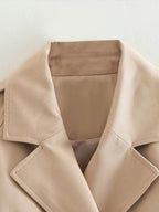 Women's beige cropped trench jacket with belt and long sleeves