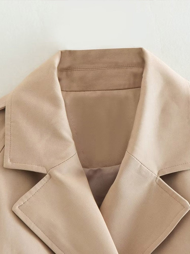 Women's beige cropped trench jacket with belt and long sleeves