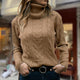 Women's cable knit turtleneck sweater with long sleeves and ribbed trims