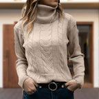 Women's cable knit turtleneck sweater with long sleeves and ribbed trims