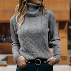 Women's cable knit turtleneck sweater with long sleeves and ribbed trims