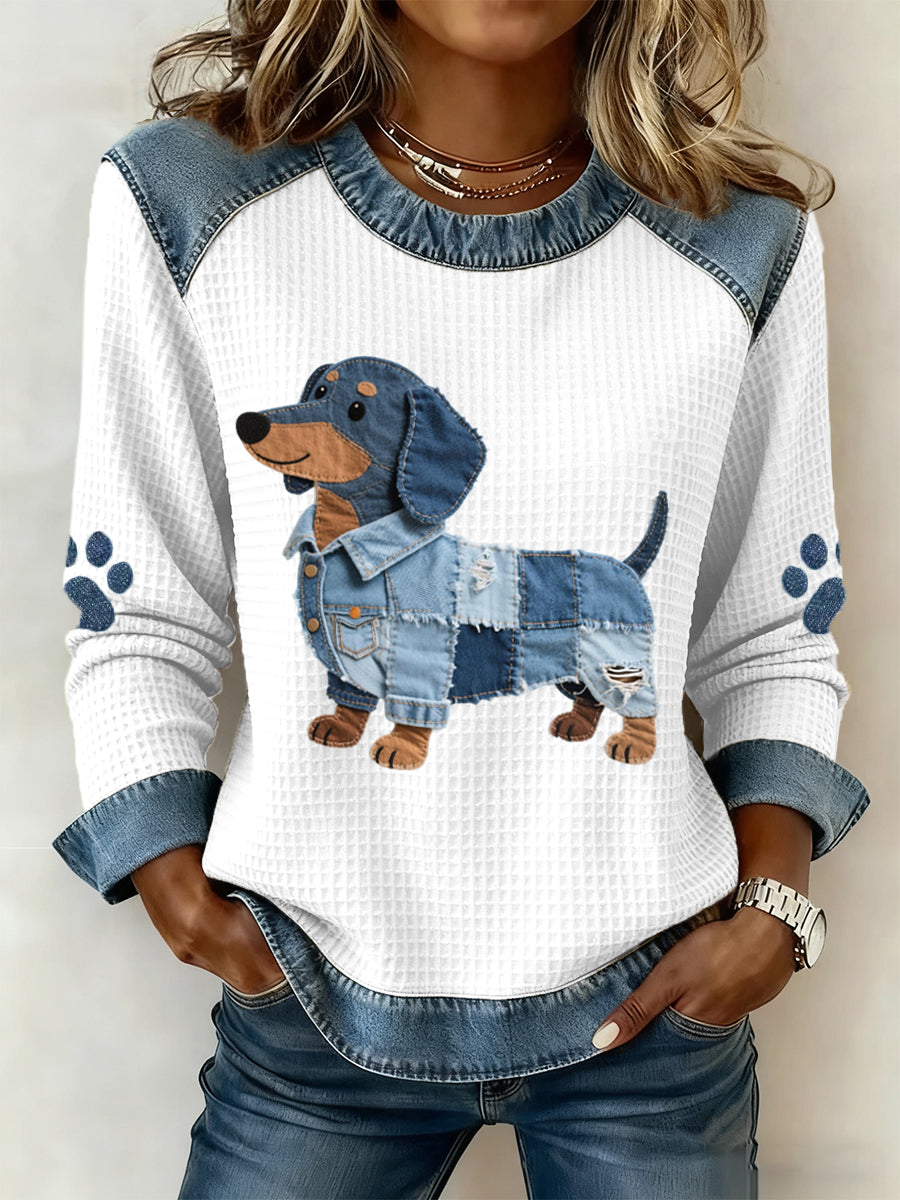 Women's blue and white sweatshirt with a patchwork dog motif and contrasting denim-look trim