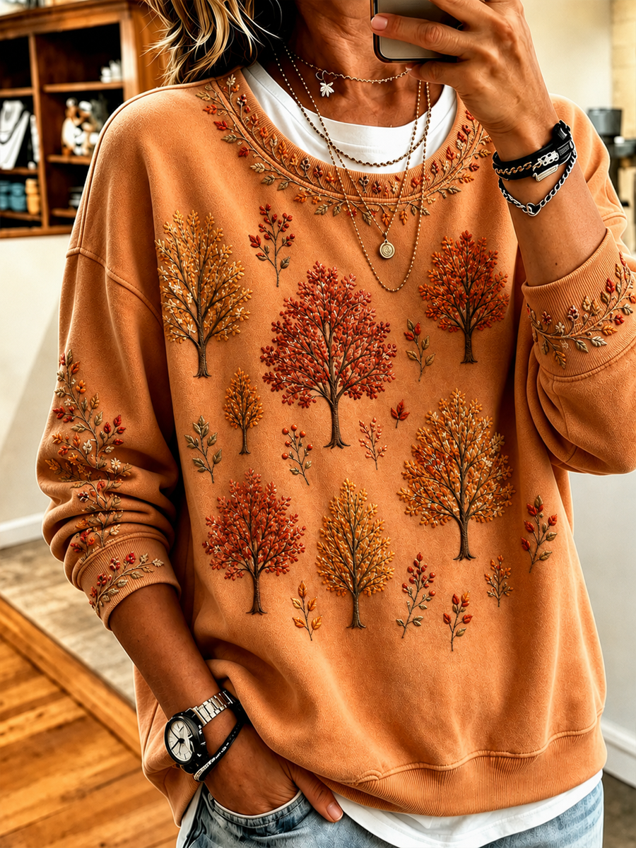 Women's orange sweatshirt with illustrated tree print and kangaroo pocket