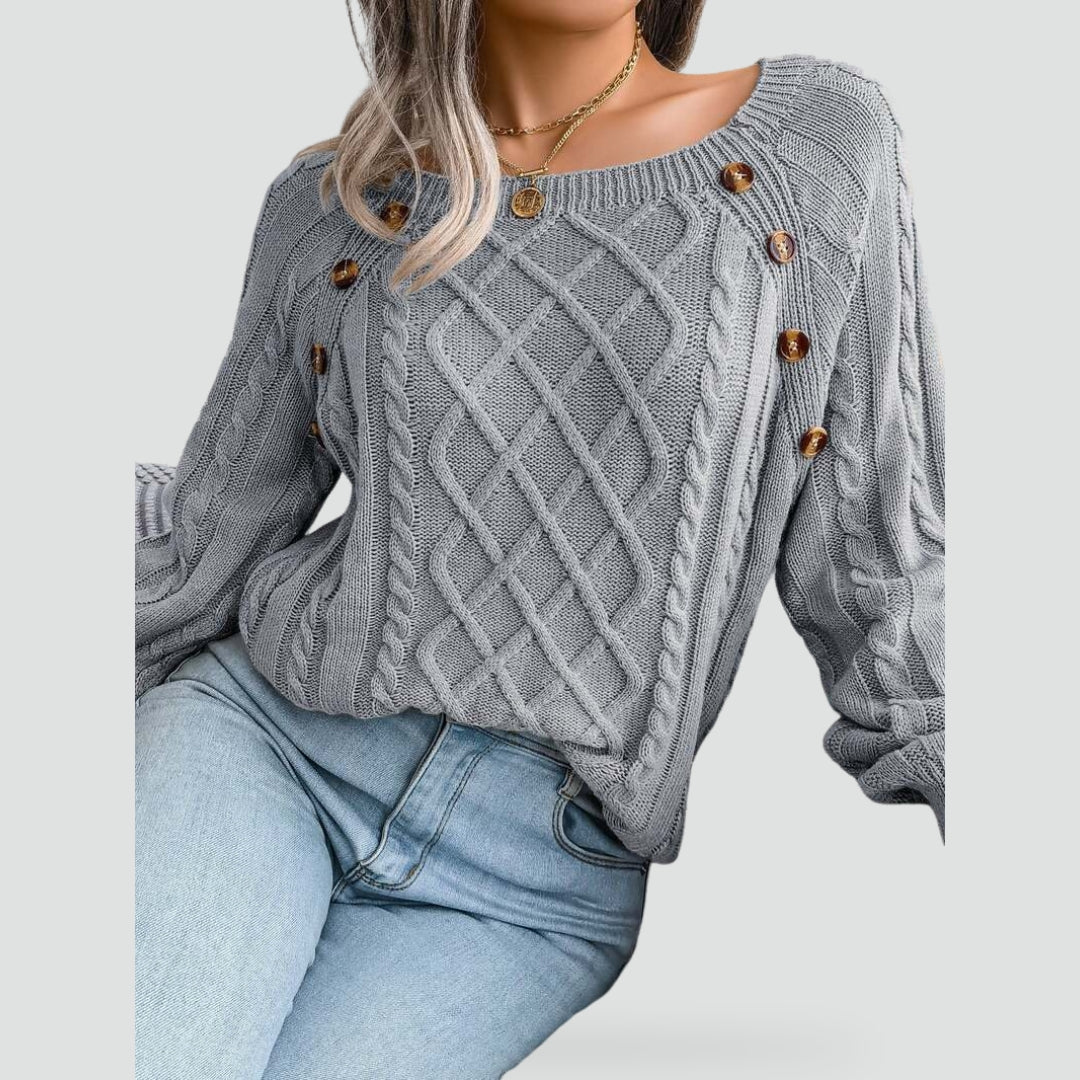 Women's cable knit sweater with diamond pattern and shoulder buttons