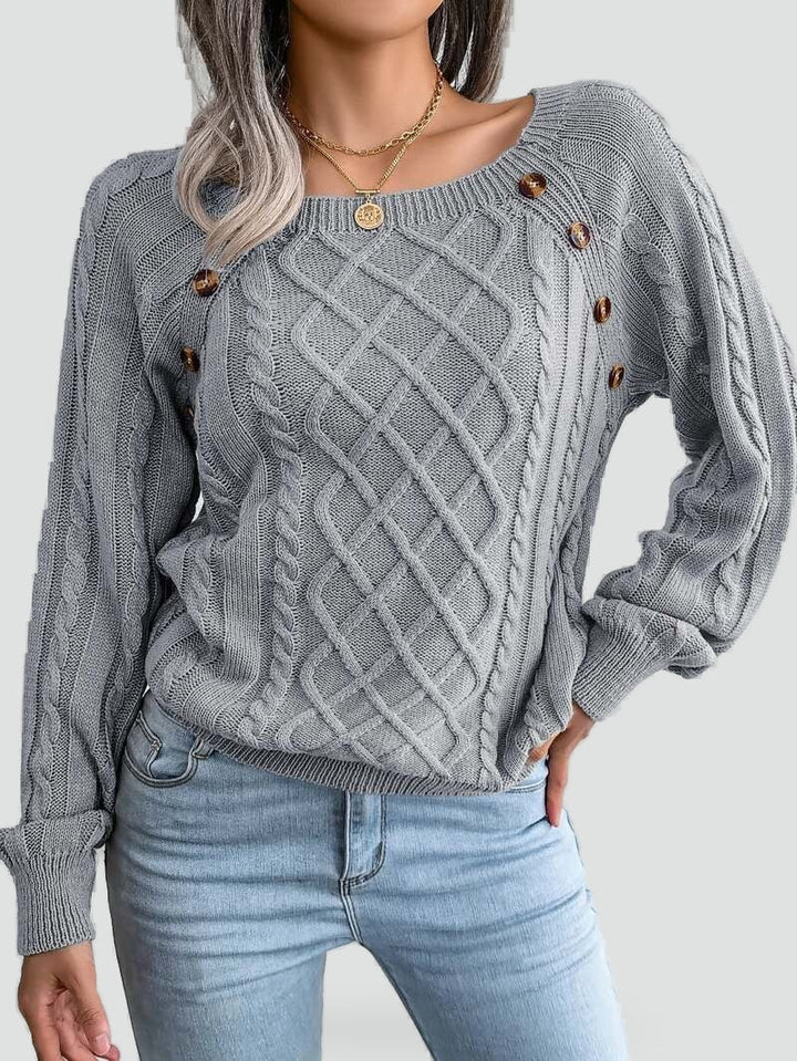 Women's cable knit sweater with diamond pattern and shoulder buttons