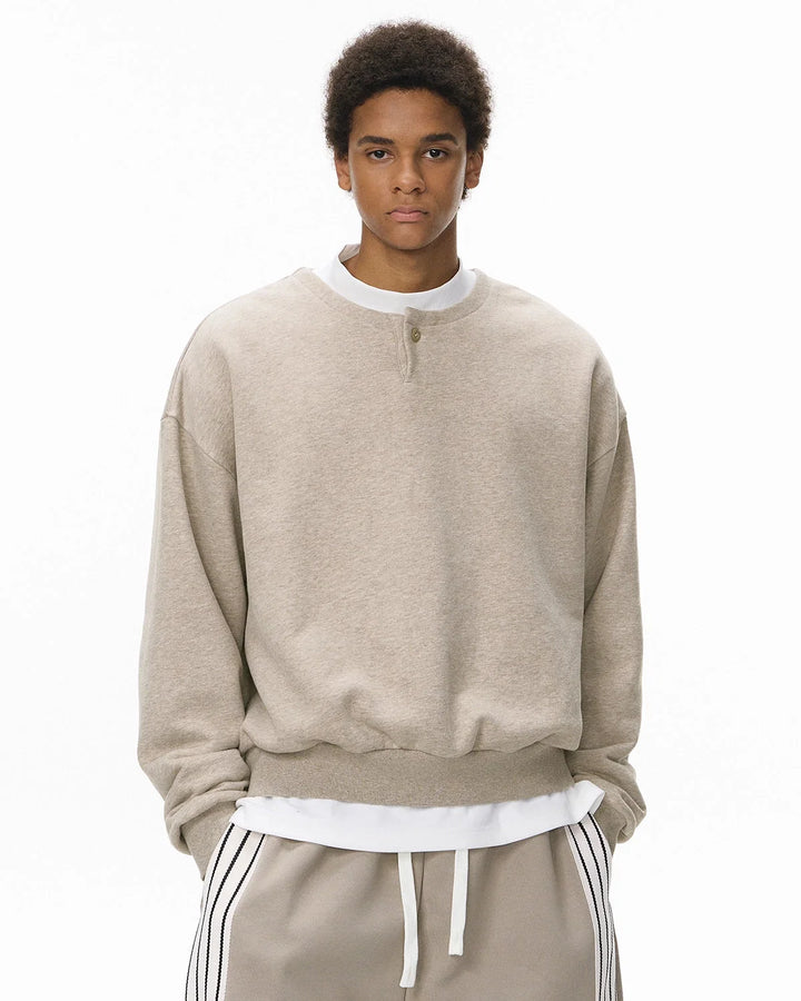 Boxy long sleeve Henley collar sweatshirt with ribbed cuffs and hem
