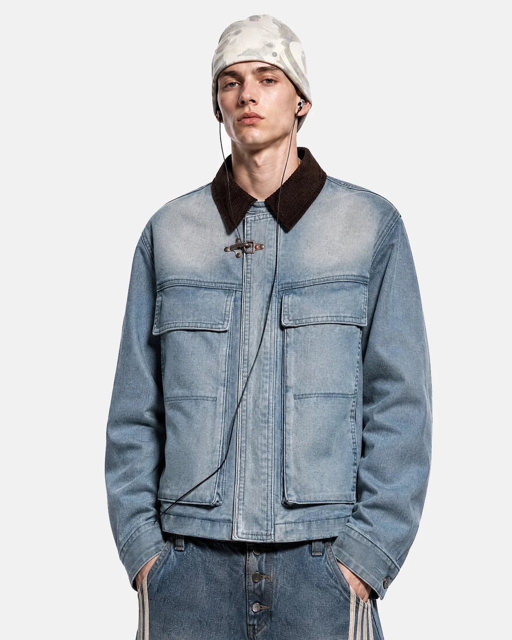 Blue boxy denim jacket with dark corduroy collar, long sleeves and multiple front pockets
