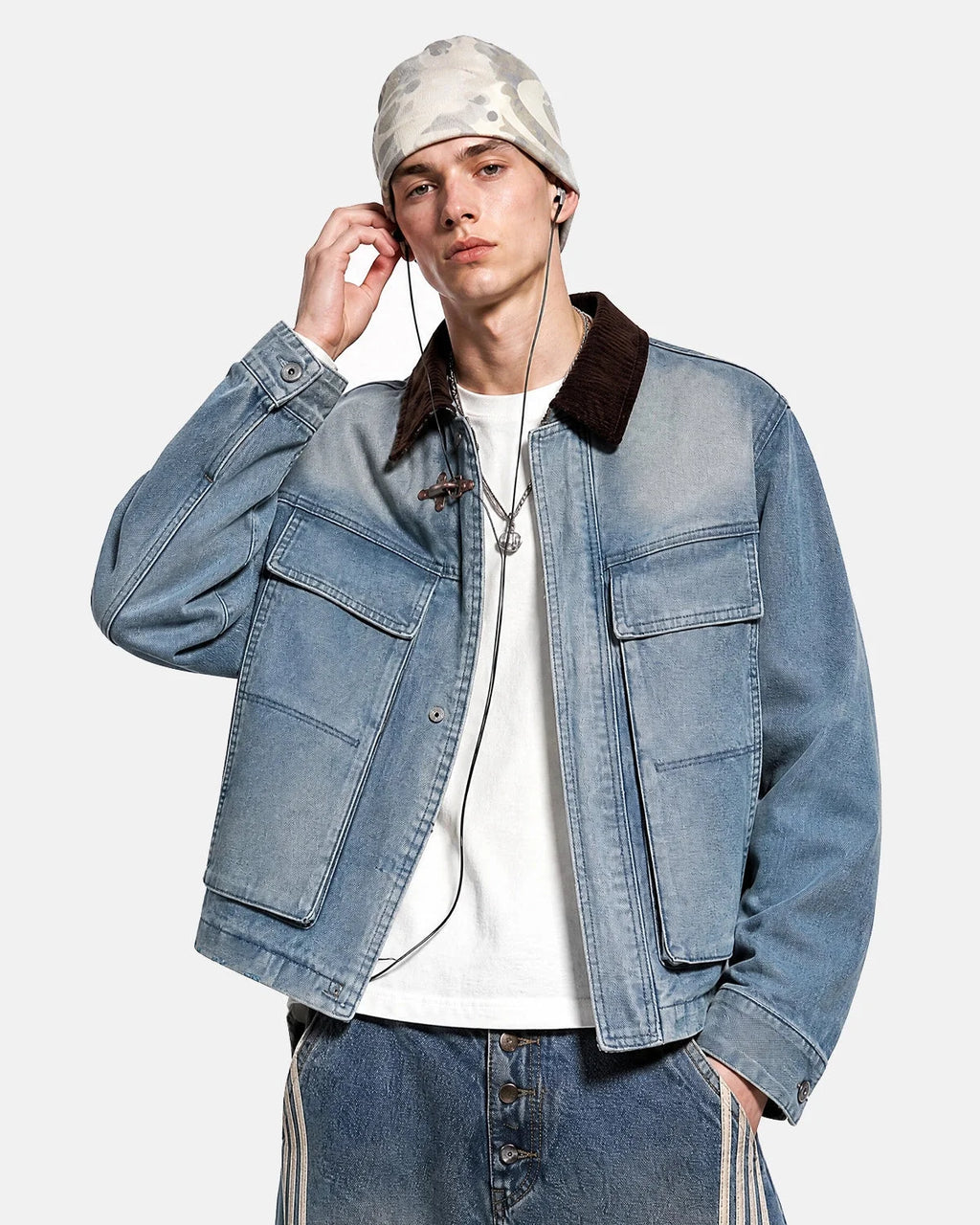 Blue boxy denim jacket with dark corduroy collar, long sleeves and multiple front pockets