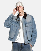 Blue boxy denim jacket with dark corduroy collar, long sleeves and multiple front pockets