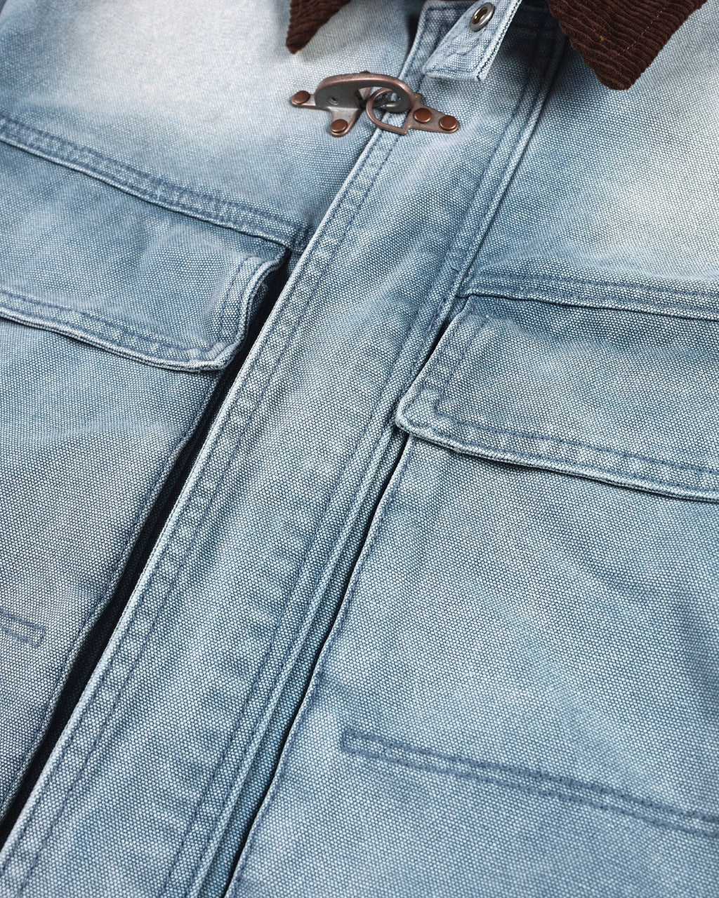 Blue boxy denim jacket with dark corduroy collar, long sleeves and multiple front pockets
