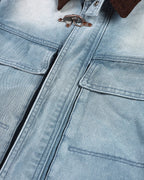 Blue boxy denim jacket with dark corduroy collar, long sleeves and multiple front pockets