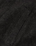 Men's black cropped denim jacket with high collar and asymmetric button front