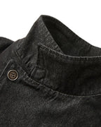 Men's black cropped denim jacket with high collar and asymmetric button front