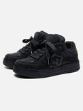 Black high-top skate trainers with textured panels and lace-up fastening