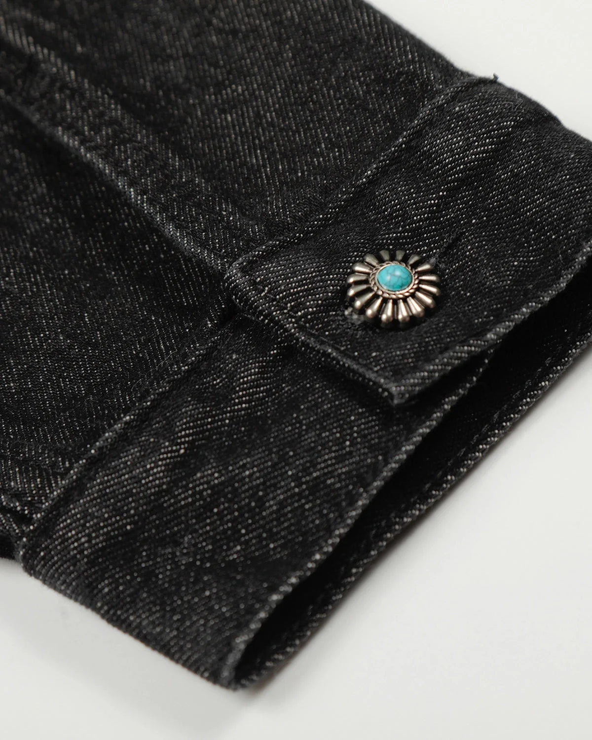 Women's black cropped denim jacket with clasp fastenings and long sleeves