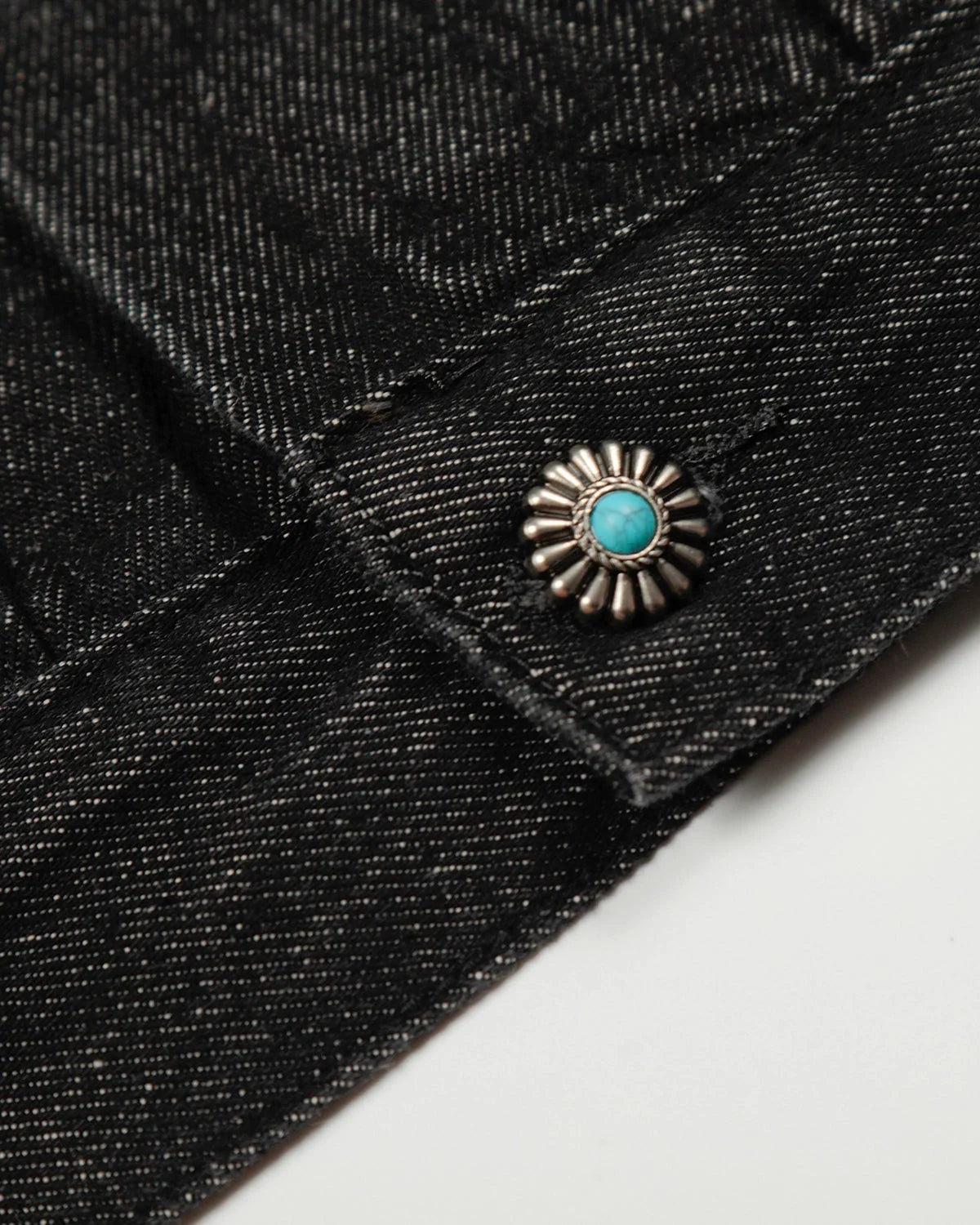 Women's black cropped denim jacket with clasp fastenings and long sleeves
