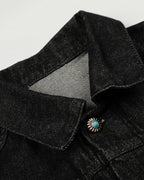 Women's black cropped denim jacket with clasp fastenings and long sleeves