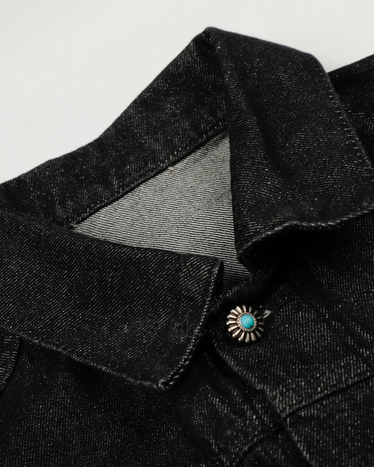 Women's black cropped denim jacket with clasp fastenings and long sleeves